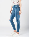 Skinny Jeans in Midwash with Busted Knees and Chewed Hems