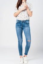 Skinny Jeans in Midwash with Busted Knees and Chewed Hems