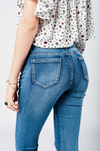 Skinny Jeans in Midwash with Busted Knees and Chewed Hems