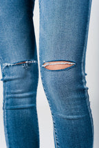 Skinny Jeans in Midwash with Busted Knees and Chewed Hems